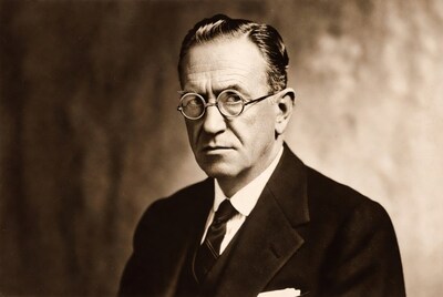 Man in suit with round glasses