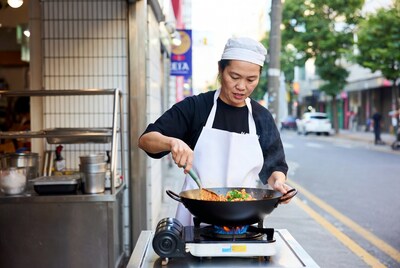 Asian woman cooking stir-fry street food