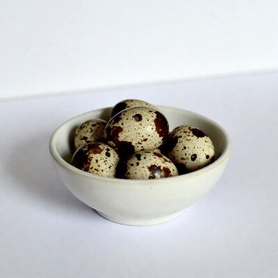 Quail eggs in white bowl