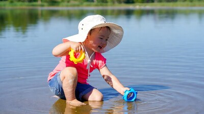 Asian girl playing with toys in lake