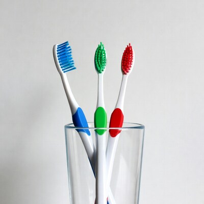 Colorful toothbrushes in glass
