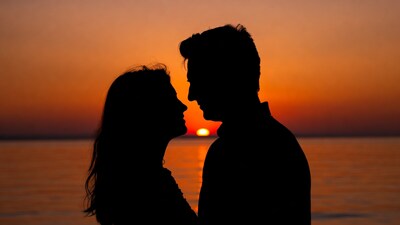 Silhouette couple kissing at sunset