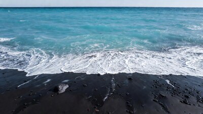 Black sand beach turquoise ocean waves