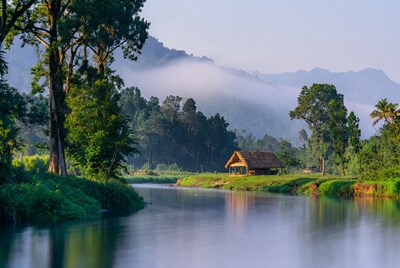 Traditional Hut by Misty River