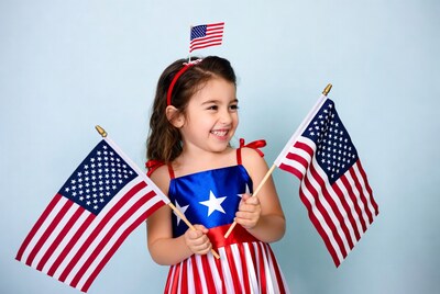 Girl holding American flags smiling