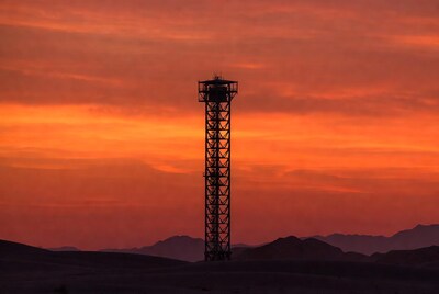 Tall tower silhouetted against sunset