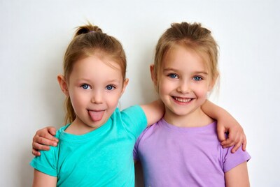 Two girls hugging sticking tongue out