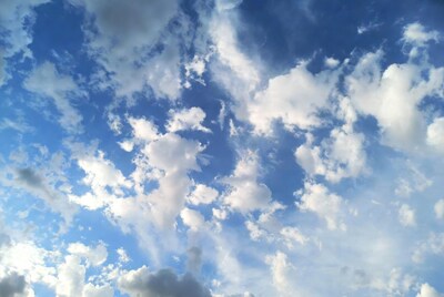 Fluffy white clouds in blue sky