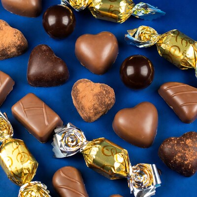 Assortment of chocolates on blue background