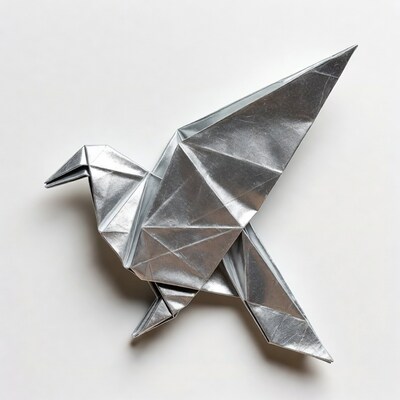 Silver origami crane on white background