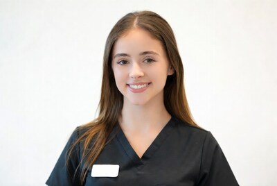 Smiling young woman in black scrubs