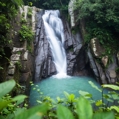 Tropical waterfall cascading into turquoise pool