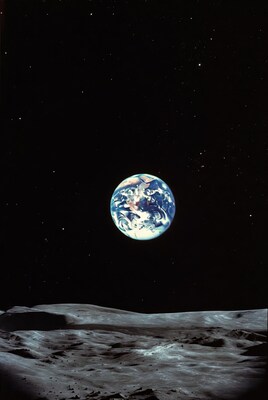Earthrise over lunar horizon