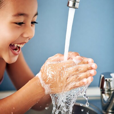 Asian girl washing hands with soap