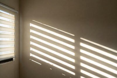 Blinds casting shadows on wall