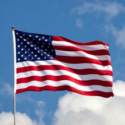 American flag waving in blue sky