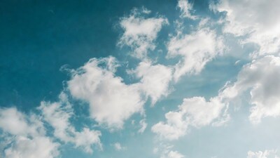 Fluffy white clouds in blue sky