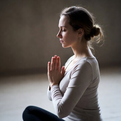 Woman in prayer pose meditating