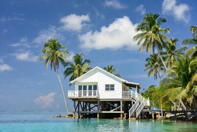 White stilt house over turquoise lagoon