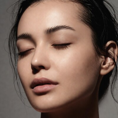 Asian woman with eyes closed closeup