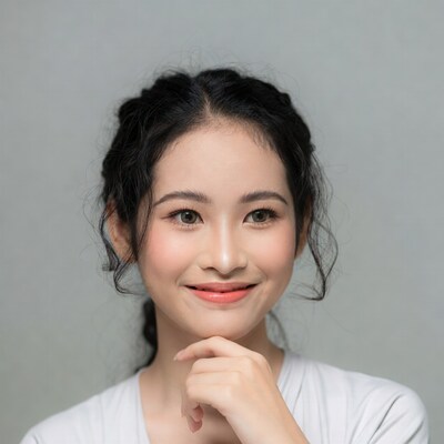 Asian woman hand on chin smiling