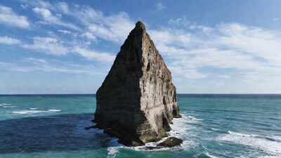Towering rock formation in ocean