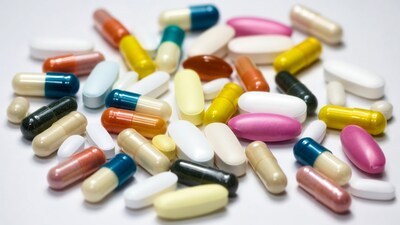 Colorful pills scattered on white background