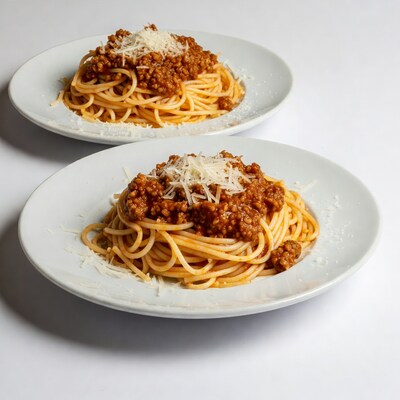 Two plates of spaghetti bolognese
