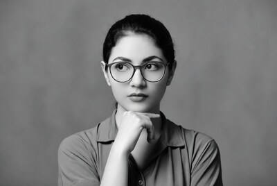 Woman in glasses chin on hand