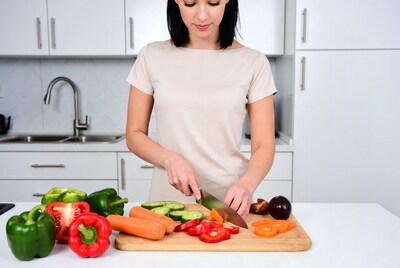 Woman chopping vegetables in kitchen