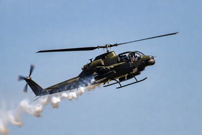 UH-1 Huey helicopter flying with smoke