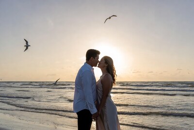 Couple kissing on beach at sunset