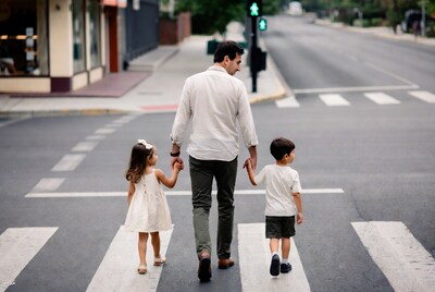 Father walking with children on crosswalk