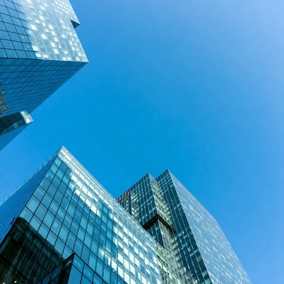 Modern glass skyscrapers against blue sky