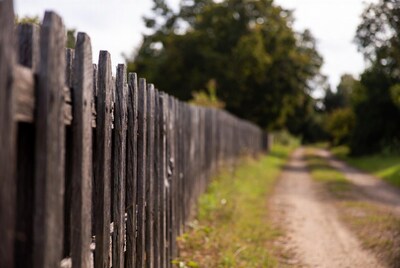 Wooden fence along dirt path