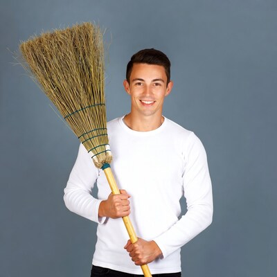 Young man holding broom
