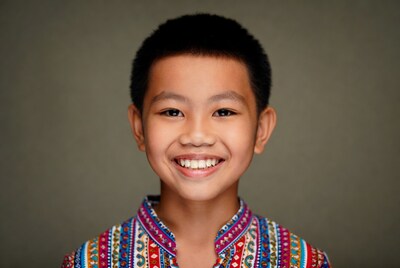 Asian boy smiling in colorful shirt