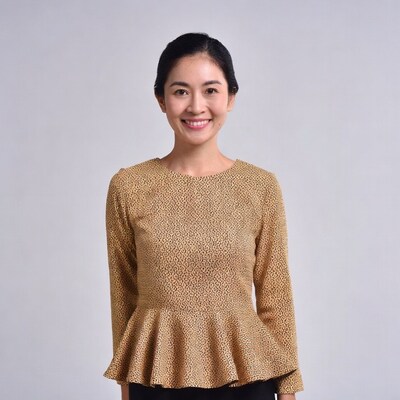 Asian woman in gold peplum blouse
