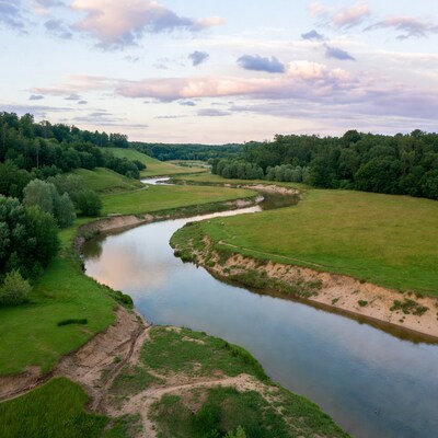 Aerial view of winding river in green valley