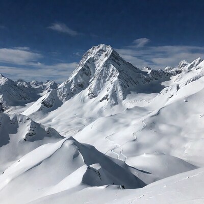 Snowy Mountain Peak with Ski Tracks