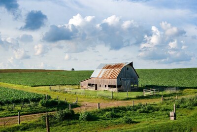 Rustic red barn in green fields