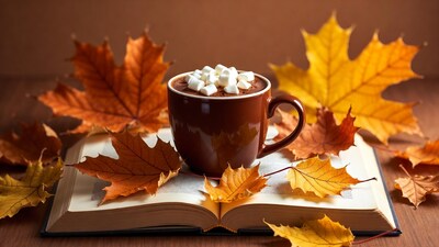 Hot cocoa mug with autumn leaves and book