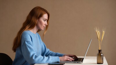 Redhead woman typing on laptop