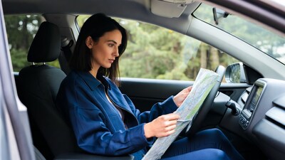 Woman reading map in car