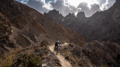 Man mountain biking rugged trail