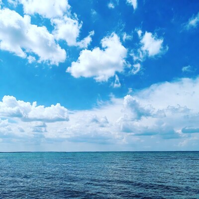 Blue sky with clouds over ocean