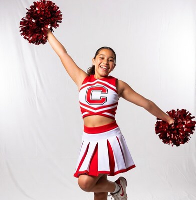 Cheerleader girl holding red pom poms
