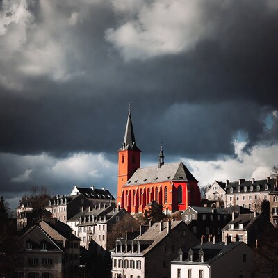 Red Church Towering Over European Town