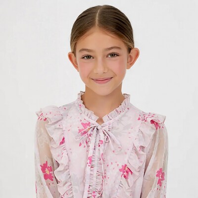 Girl in pink frilly dress smiling