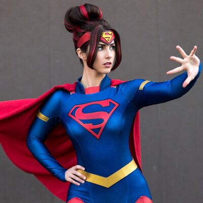 Woman in Supergirl cosplay striking pose